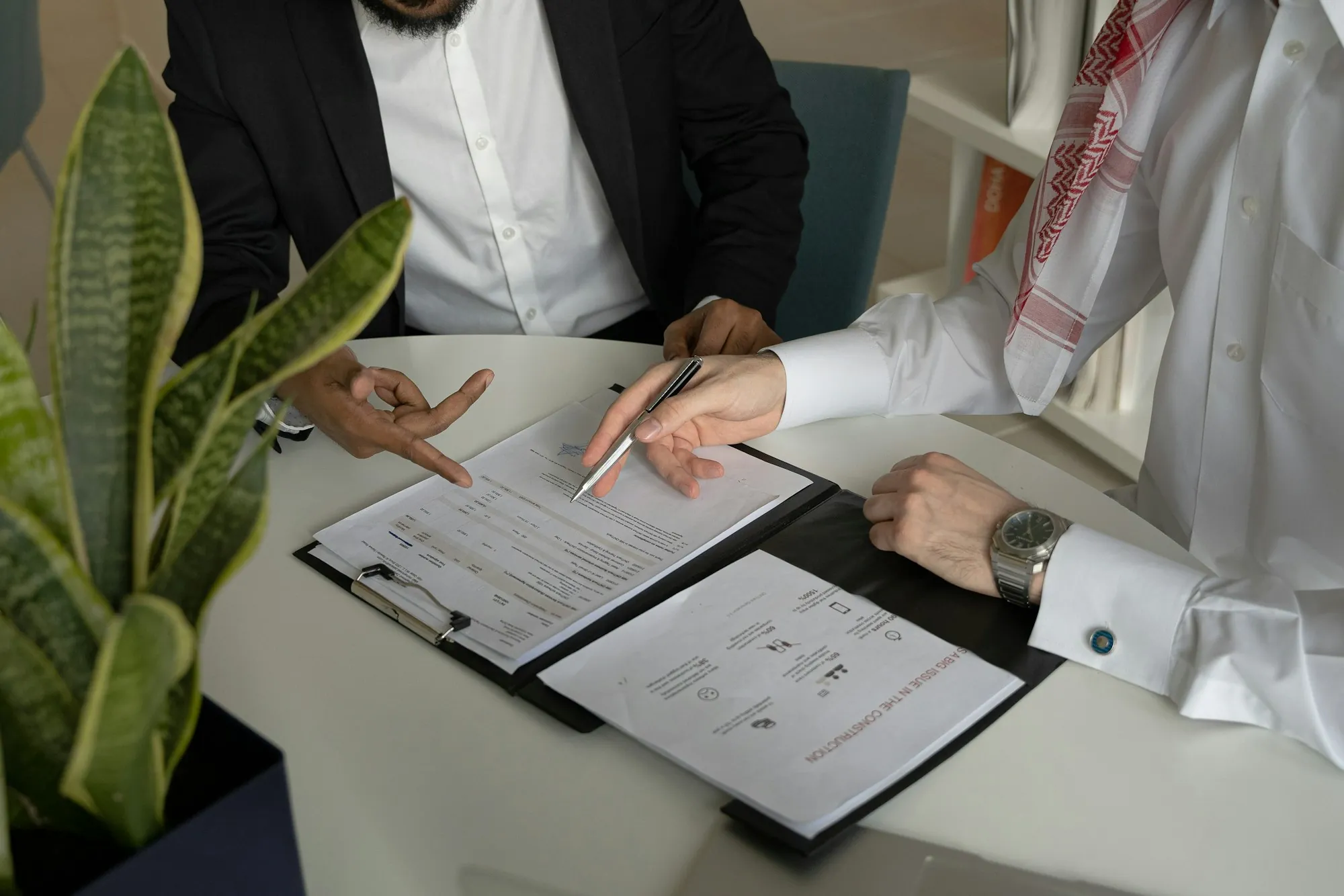 Two people going over a document on a clipboard